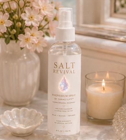Salt Revival on a vanity with flowers and candle